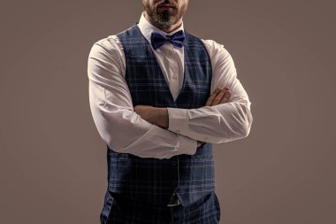 cropped view of confident tuxedo man in formalwear with bowtie. tuxedo man in formalwear isolated on grey background. tuxedo man in formalwear at studio. tuxedo man wear formalwear fashion.