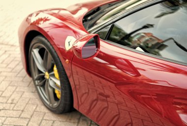 Miami Beach, Florida USA - April 18, 2021: car side mirror of red Ferrari.