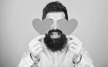 Expressing his love. Sexy valentine man covering eyes with love cards. Hipster with small hearts. Bearded man holding red hearts. Happy valentines day. Spreading more love.