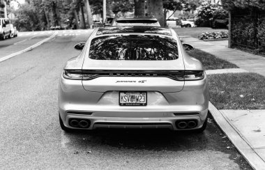New York City, ABD - 26 Ağustos 2023: Porsche Panamera spor araba gümüş rengi park edilmiş, arka görüş.