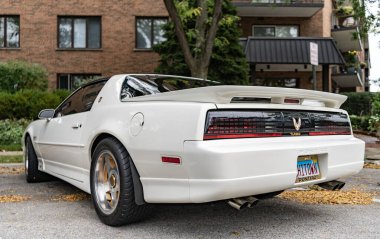 Chicago, Illinois - September 29, 2024: 1992 Pontiac Firebird Trans Am GTA white color. 1992 Pontiac Firebird Trans Am GTA parked on the street. back view clipart