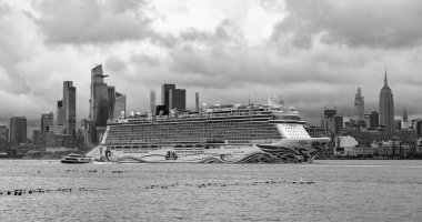 New York, USA - July11, 2023: Cruise ship Norwegian Joy Sailing next to Manhattan in New York. Skyline of New York Manhattan cruising on the Hudson River cruise liner NCL. clipart