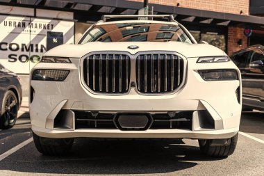 New York City, USA - March 31, 2024: 2023 BMW X7 modern white car parked outdoor, front view. clipart