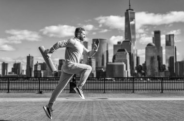 Spor antrenmanında koşan koşucu. Sporcu koşucu ya da koşucu. Spor takım elbiseli bir adam koşu yapıyor. Manhattan 'da koşan adam. New York 'ta sabah sporu koşucusu. Kişisel sporlar.