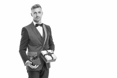 smiling businessman in tuxedo with box isolated on white. boxing day.