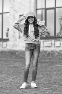 happy teen girl skateboarding outside. teen girl skateboarding at the street. photo of teen girl skateboarding with skateboard. teen girl skateboarding outdoor.