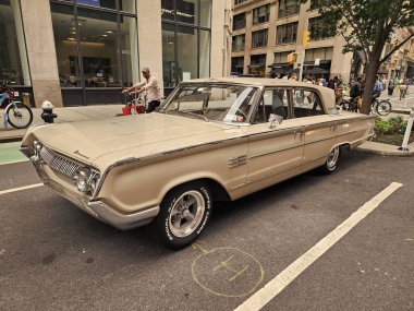 New York City, USA - August 17, 2023: Mercury Montclair 1964 vintage car parked at the street, side corner view. clipart