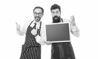 partners celebrate start up. catering business. welcome on board. cafe and restaurant opening. menu planning. happy chef team in apron. bearded men with blackboard, copy space. champions in kitchen. clipart