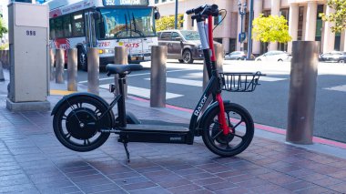 San Diego, California, USA - May 17, 2019: Razor EcoSmart Metro Electric Scooter Chain-Driven. Electric scooter Razor. Urban transport of electric scooter. Electric scooter vehicle outdoor. clipart