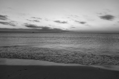 romantic view on sunset with sea water on the summer beach.