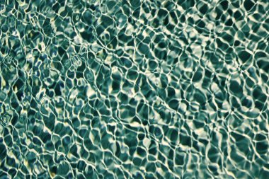 Yazın yüzme havuzunda dalgalı su mavisi.