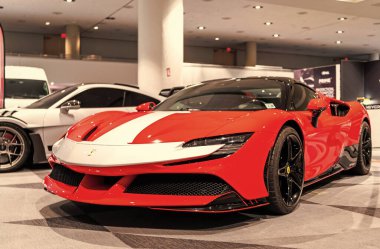 New York City, USA - March 27, 2024: Ferrari SF90 Stradale sportscar red car at New York International Auto Show, corner view. clipart