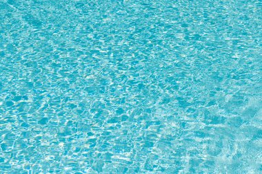 Mavi havuz arka planında deniz dalgaları. Deniz arka planı. Yüzme havuzu dalgalandı. Yaz tatili. Yaz tatilinde spa merkezi. Havuz kenarında su yüzeyi olan bir tatil köyü. Hafta sonu kaçamağı.