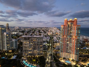 Miami South beach at night. Aerial view on skyscraper cityscape at night. Night city aerial view. Luxury skyscraper. Illuminated. City skyline in evening sundown. Aerial cityscape. Vibrant nightlife. clipart