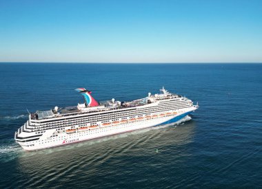 Miami, Florida, ABD - 22 Kasım 2024: Karnaval Fetih yolcu gemisi denizde. Gemi sahil limanından ayrılıyor. Gemi seyahati. Gemi seyahati ve deniz seyahati. Karnaval Gemi Hattı.