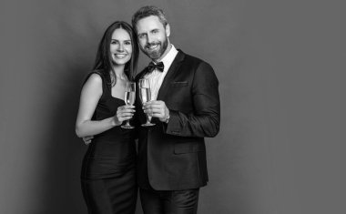 Aşık çift nişanı kutluyor. Zarif çift kırmızıda izole edilmiş şampanya içer. Resmi olarak bir çift. Romantik randevu kutlamaları. Sevgililer Günü. Yıldönümünü kutlayalım. Boşluğu kopyala.