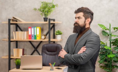 serious unshaven boss wear suit in the office with copy space, charisma.