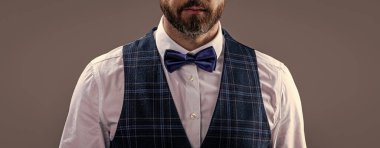 studio shot of tuxedo man in menswear. tuxedo man wear menswear fashion. cropped view of elegant tuxedo man in menswear with bowtie. tuxedo man in menswear isolated on grey background.
