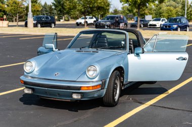 Chicago, Illinois, USA - September 08, 2024: Porsche 911SC Targa retro convertible sportscar, front view. Retro car. Retro Porsche 911SC Targa car. Convertible Triumph Spitfire at Chicago clipart