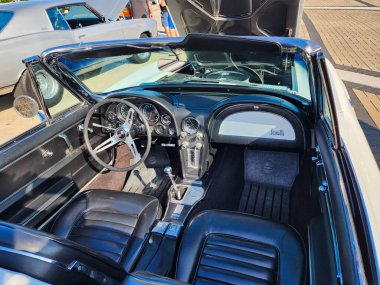 Park Ridge, Illinois, USA - August 21, 2024: Chevy Corvette. Retro convertible car parked at auto show, interior view. Chevrolet Corvette C2 retro car. Convertible car of Chevrolet Corvette C2. clipart