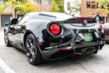 Chicago, Illinois - September 29, 2024: 2015 Alfa Romeo 4C Coupe black color. P2015 Alfa Romeo 4C Coupe parked on the street. corner view. 2015 Alfa Romeo 4C Coupe in Chicago clipart