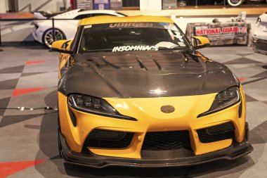 New York City, ABD - 27 Mart 2024: Toyota GR Supra spor araba sarı araba New York Uluslararası Otomobil Fuarı, ön manzara.