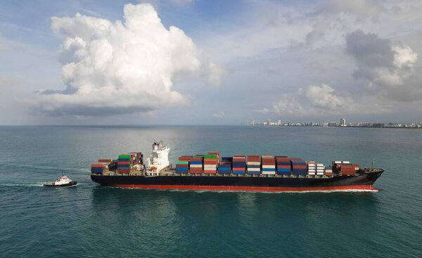 Container ship. Shipping logistics. Commercial shipping. Cargo ship in sea, aerial view. Freight container on cargo vessel. Aerial view cargo ship entering harbor. Cargo business. Shipping industry.