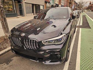 New York City, ABD - 10 Mart 2024: BMW X6 araba siyah dışarıda, köşe manzaralı.