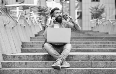 Serbest iletişim kuran gülümseyen adam telefonda konuşuyor. Dizüstü bilgisayarında serbest iletişimi olan bir adam. Dışarıda serbest çalışan bir adam var. Serbest iletişimi olan bir adam..