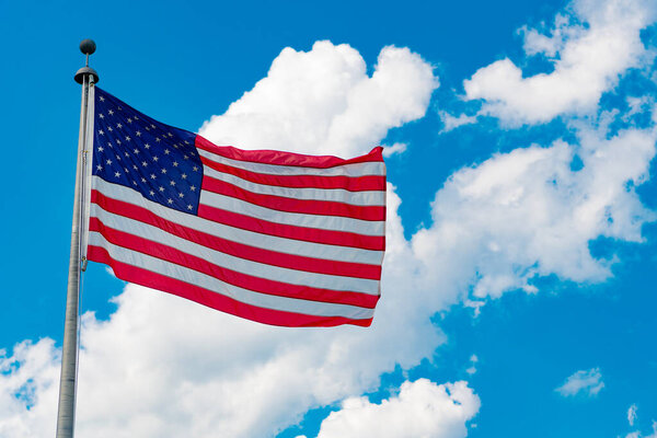 American flag waving for independence day. Flag of the USA. National waving flag of united states on blue sky. Independence day. Patriotic symbol. American Flag for Memorial Day or 4th of July.