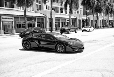 Miami Beach, Florida USA - April 15, 2021: mclaren exclusive 570GT MSO Black, side corner view.