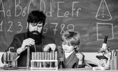 Educational school program. Teacher and child test tubes. School lesson. Perseverance pays off. Chemical experiment. Symptoms of ADHD at school. Schoolboy cute child experimenting with liquids.