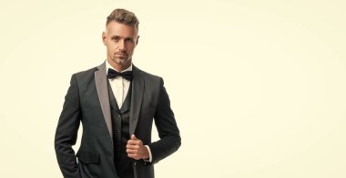 elegant man waiter with bowtie isolated on white background. full length.