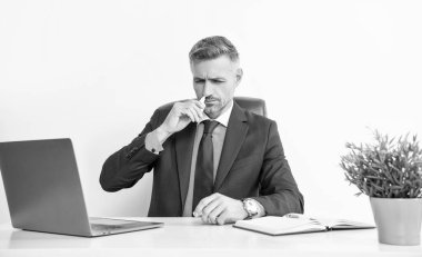 mature man with runny nose use nasal drops.