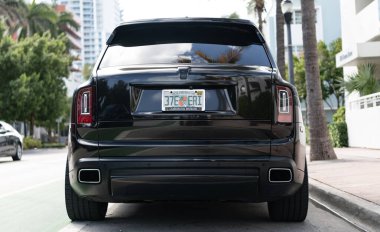 Miami, Florida, ABD - 06 Aralık 2024: Rolls Royce Cullinan 2020 Crossover Car. Rolls Royce Cullinan 'ın siyah Crossover arabası. Araba Rolls Royce Cullinan dışarı park etmiş. Rolls Royce Cullinan, ön manzara.