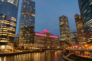 Nehirdeki Chicago gökdelenin mimarisi. Şehir gecesi aydınlatılmış bina. Gökdelen şehir manzarası. Chicago, Illinois 'de bir gece şehri. İş şehri. Chicago gökdelen binasının gece manzarası.