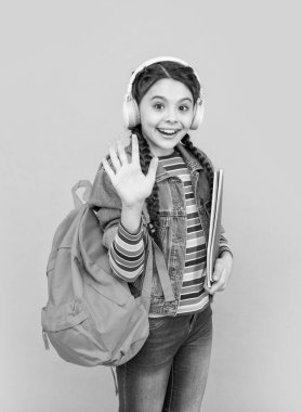 Hello school. Happy teen girl waving hand blue background, school. Back to school. September 1. Knowledge day.