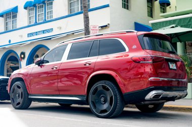 Miami, Florida, ABD - 16 Aralık 2024 Mercedes Benz Maybach GLS 600 'ün kırmızı lüks SUV arabası. Mercedes Benz 'in arabası dışarıda park edilmiş. Mercedes Benz GLS kırmızı renk, yan görünüm. Mercedes Benz GLS SUV araba.
