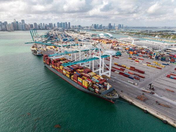 Miami, Florida - February 12, 2025: Port of Miami. Cargo ship loaded with container in Miami, aerial. Freight container. Aerial Miami port with cargo container. Export and import.