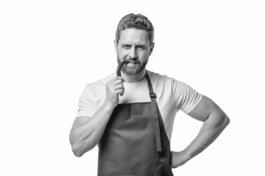man in apron bite chili vegetable isolated on white.
