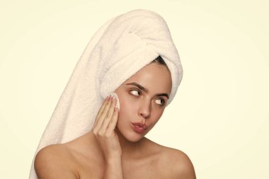 Makyajı sil. Güzellik rutini. Havluyla yüz temizleyen kadın derisi. Pamuk yumağıyla deriyi temizliyor. Cilt kozmetolojisi. Kaplıcada güzellik günü. Kadın pamuk pedi kullanıyor. Cilt bakımı. Cilt tazeleme.