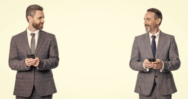 Telefondaki mesajlaşan iş adamları beyazdan izole edilmiş. İş mesajlaşması. İnternet işi. Takım elbiseli iş adamları telefon kullanır. Blogda sohbet eden iki iş adamı. reklam.