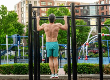 Güçlü bir atlet. Adam yanaşıyor. Güçlü sırt kası olan kaslı bir sporcu. Spor barfiks egzersizi. Spor eğitimi. Sporcu adam egzersiz yapıyor. Kas kasları ve trisepsler. Tekniği kaldır..
