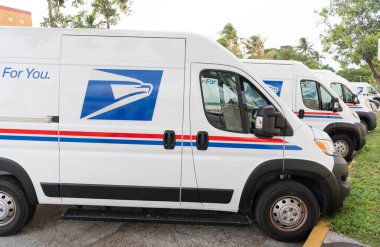 Miami, Florida, ABD - 18 Kasım 2024: USPS kamyonu. Posta servisinin kargo kamyonu. Posta kamyonu dışarıda park edilmiş. USPS posta dağıtım kamyonu, yan görünüm.