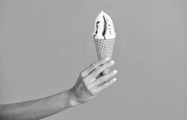 Мороженое с мороженым. Конус мороженого изолирован на апельсине. Летний ванильный вкус. Женщина держит мороженое за руку. Мороженое в руке. Вкусное летнее мороженое. Итальянское мороженое.