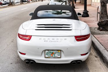 Miami, Florida, ABD - 17 Kasım 2024: 2015 Porsche 911 Carrera S arabası. Porsche Carrera S tipi lüks bir araba. Porsche Carrera 'nın arabası dışarıda park edilmiş. Porsche 911 Carrera, arka manzara.