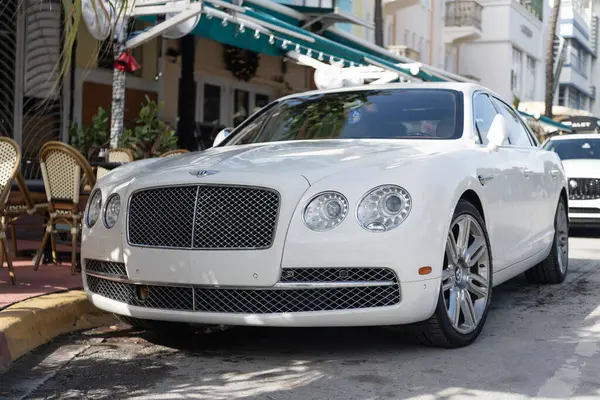 Miami, Florida, ABD - 17 Aralık 2024: 2016 Bentley Flying Spur Vur Sedan Car. Lüks araba beyaz Bentley Flying Spur V8 tipi. Bentley Uçan Mahmuz 'un arabası dışarıda park edilmiş. Bentley Uçan Mahmuz, köşe manzaralı..