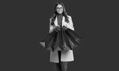 Genç kız gardırobu yeniledi. Alış veriş ve indirim. Alışveriş yapan kız kırmızıda izole edilmiş. Alışveriş kolik kız torbası. Siber pazartesi indirimi. Kız alışverişi.