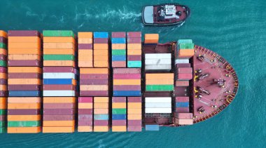 Konteynırlı kargo gemisi, hava manzaralı. Kargo gemisinde nakliye konteynırı. Kargo gemisi limandan ayrılıyor. Konteyner gemisi. İhraç ve ithalat. Kargo işi. Nakliye lojistiği.