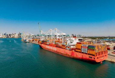 Miami, Florida, ABD - 20 Mart 2025: Kargo gemisi. Miami limanı. Konteyner ihracat gemisi. Kargo Hamburg Sud konteynır hizmetleri Miami 'de, hava manzaralı. Kargo gemisinde nakliye konteynırı.